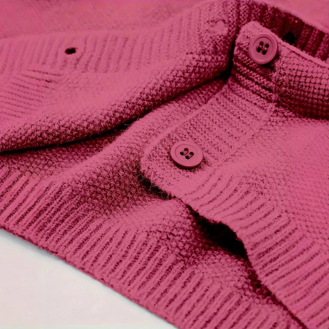 Close-up of pink textured knitted cardigan with buttons and ribbed edges