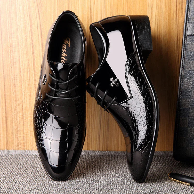 Black men's shiny dress shoes with croc pattern and lace-up design on wooden floor