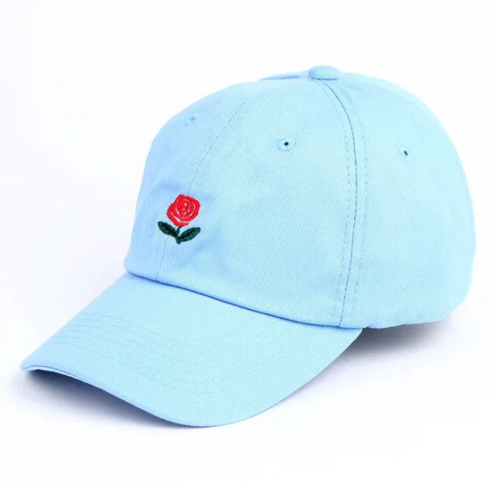 Light blue baseball cap with small embroidered red rose and green leaves on front