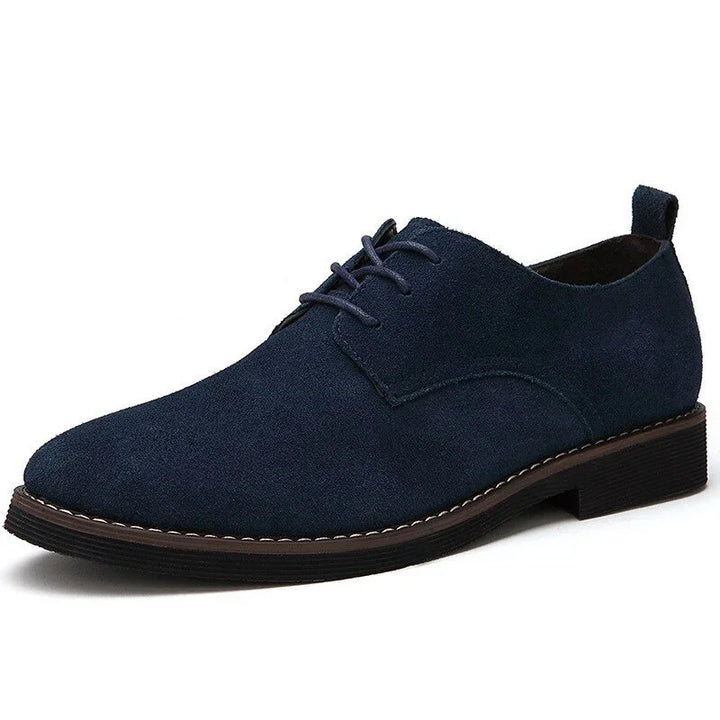 Men's navy blue suede dress shoe with lace-up design and dark rubber sole