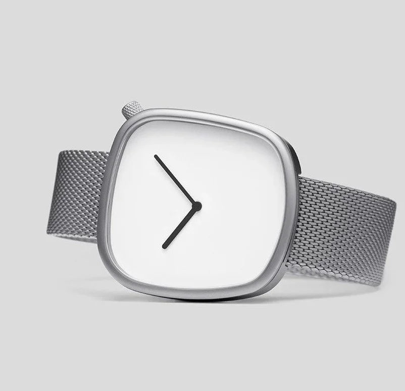 Minimalist silver wristwatch with square white face and black hands on mesh steel strap