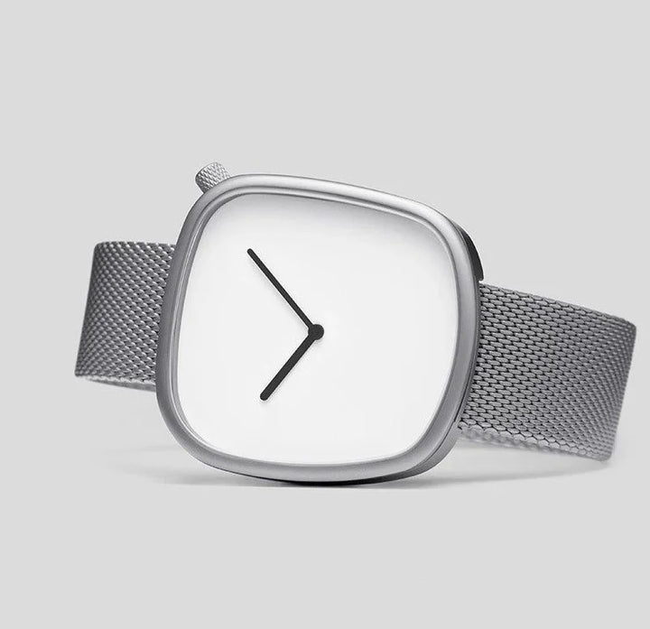 Minimalist silver wristwatch with square white face and black hands on mesh steel strap