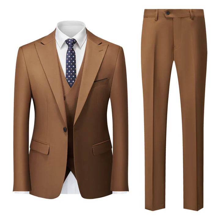Men's brown suit jacket and matching trousers with white shirt and navy patterned tie