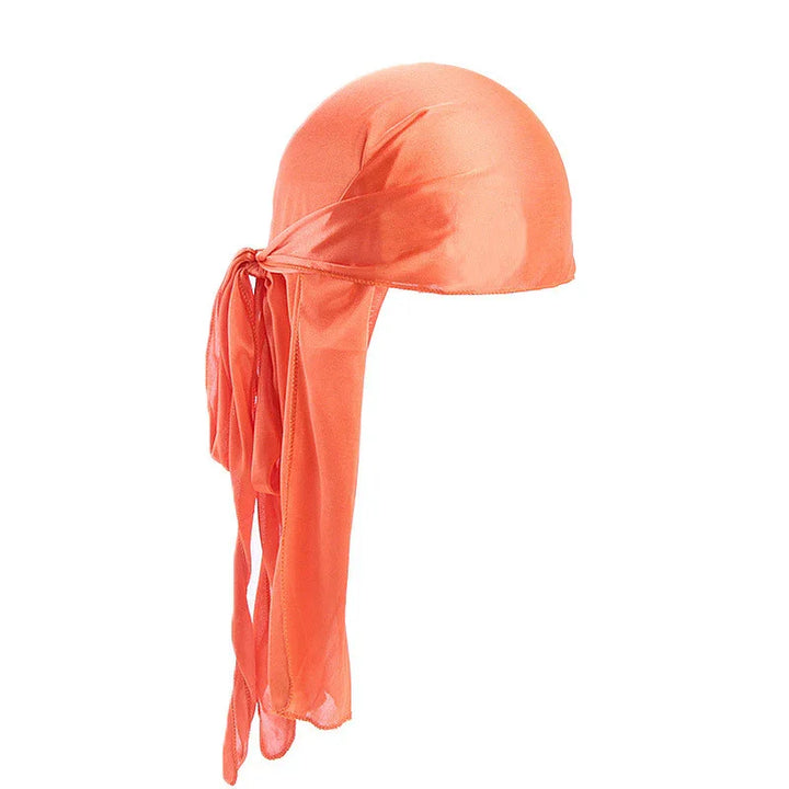Orange satin durag with long tails, smooth texture, isolated on white background