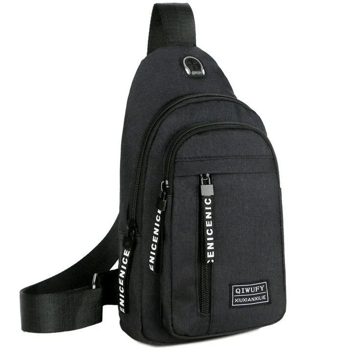 Black sling backpack with multiple zippered compartments and branded pull tabs on white background