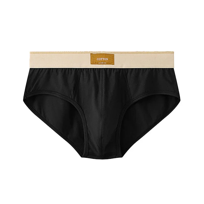 Black cotton men's briefs with beige waistband and cotton label on white background