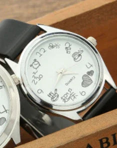 Silver quartz watch with black leather strap featuring cute cartoon number designs on white dial