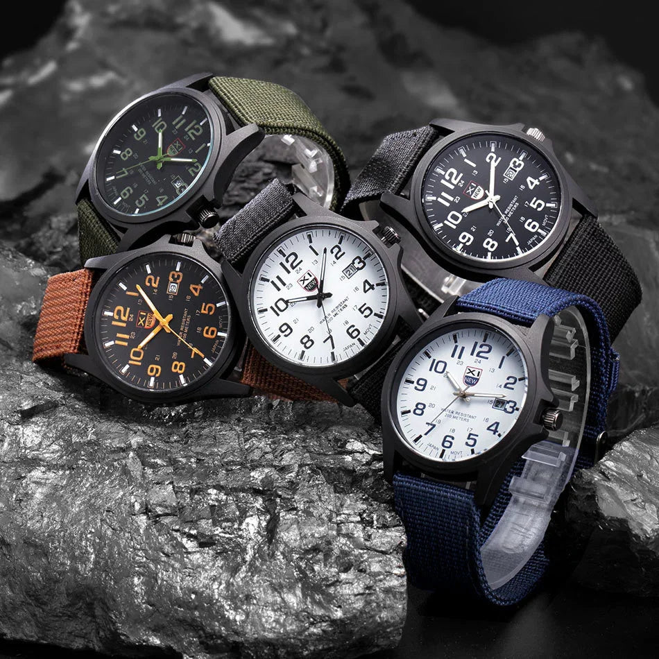 Five analog wristwatches with nylon straps in green, black, blue, brown, and gray on a textured metallic rock