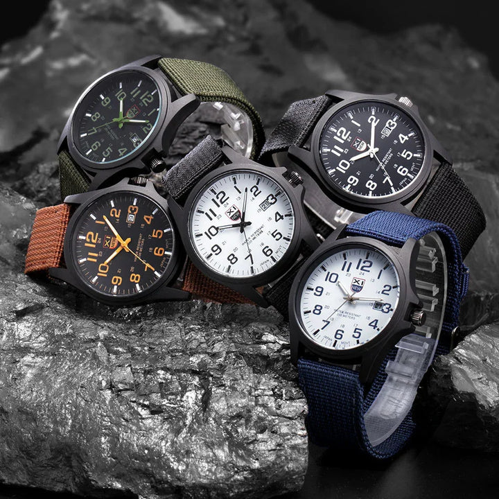 Five analog wristwatches with nylon straps in green, black, blue, brown, and gray on a textured metallic rock