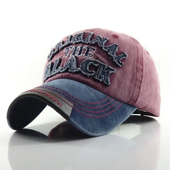 Vintage style pink and blue baseball cap with embroidered text 'ORIGINAL THE BLACK' and decorative stitching