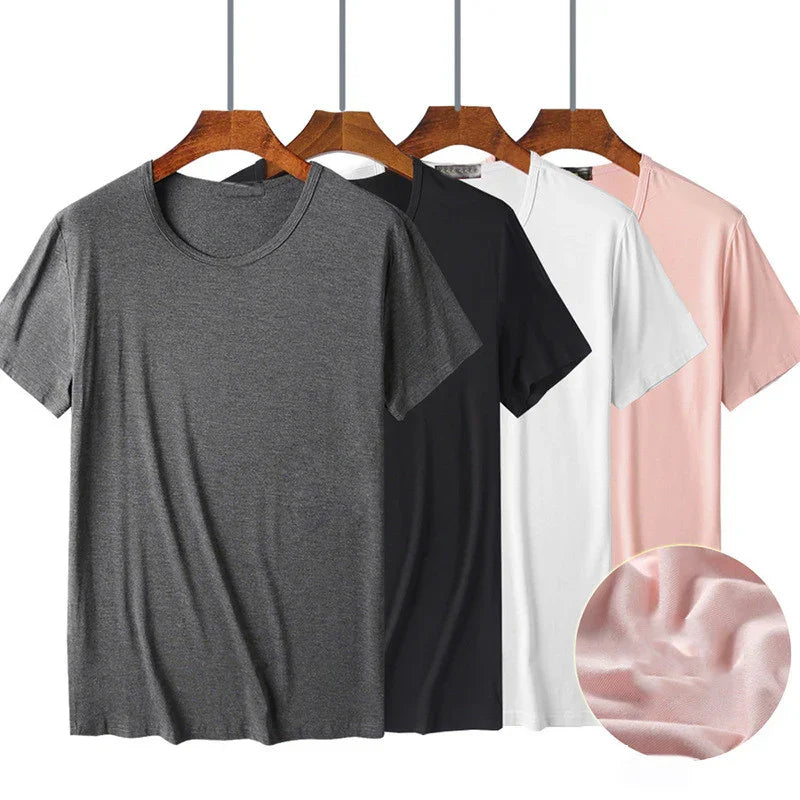 Set of four casual cotton t-shirts in gray, black, white, and pink on wooden hangers