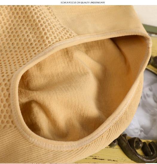 Close-up of beige seamless cotton underwear with honeycomb texture on wooden surface