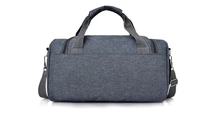 Grey fabric duffel bag with dual handles and adjustable shoulder strap on white background