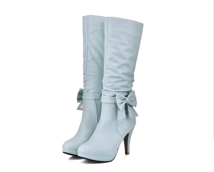 Light blue high-heeled knee boots with decorative bows and slouchy upper design