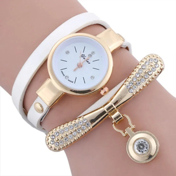 Elegant women's wristwatch with white leather strap and gold-tone decorative bracelet with rhinestones