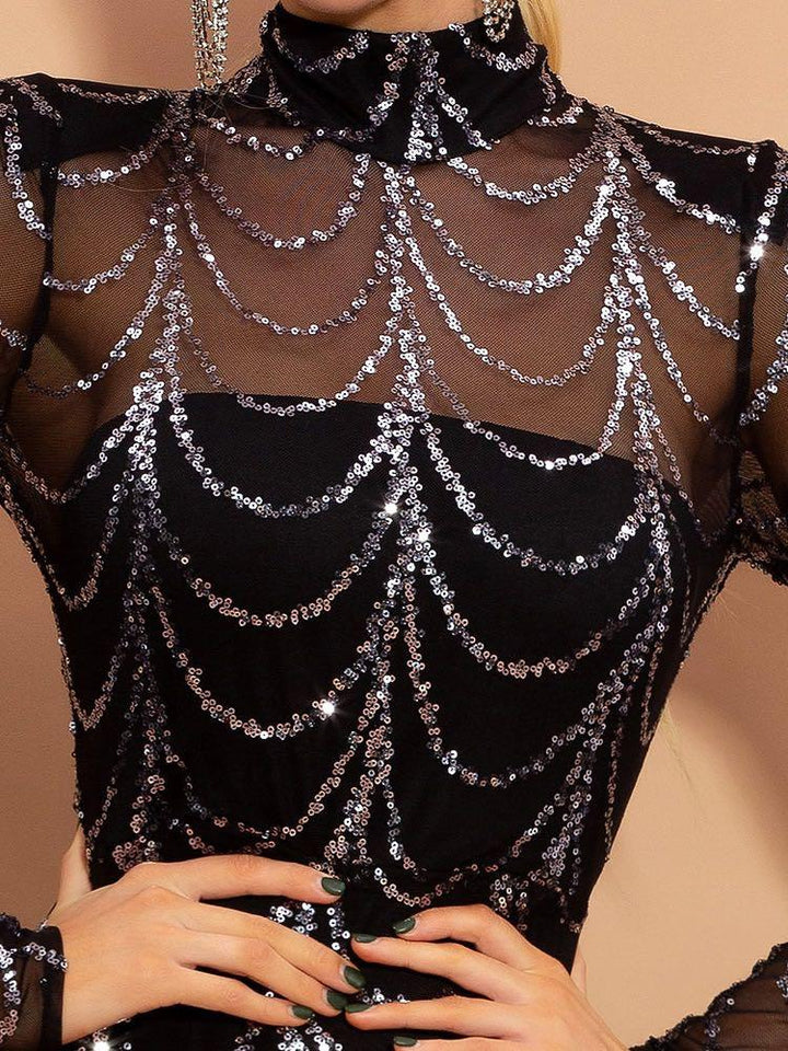 Black sheer mesh top with silver sequin draped chain pattern and high neckline, styled on model