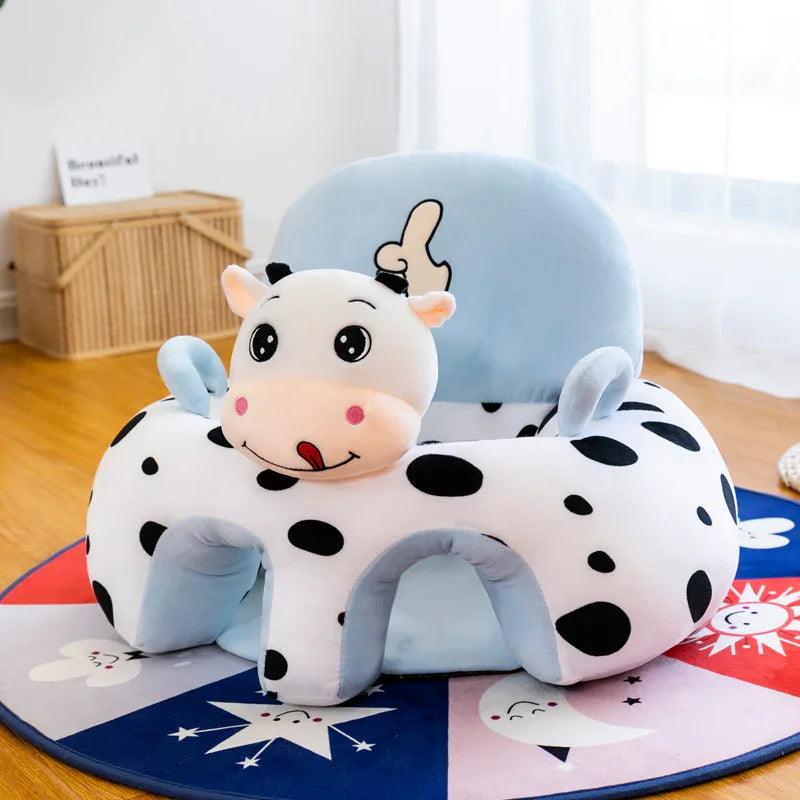 Plush cow-shaped baby floor seat with black spots, blue backrest, and playful face on colorful star and moon rug