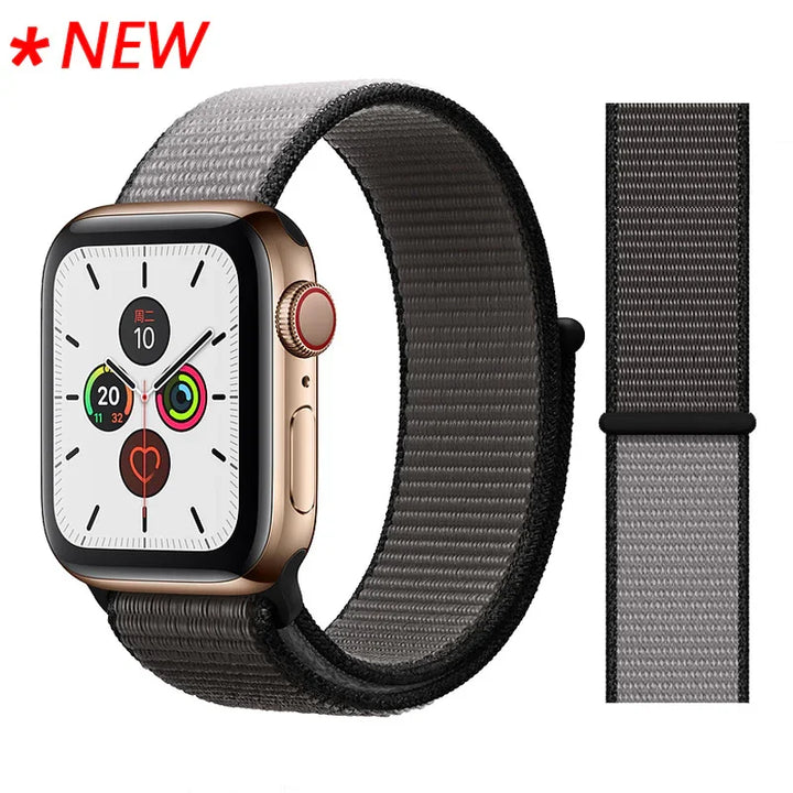 New Apple Watch with gold case and black gray woven nylon band on white background