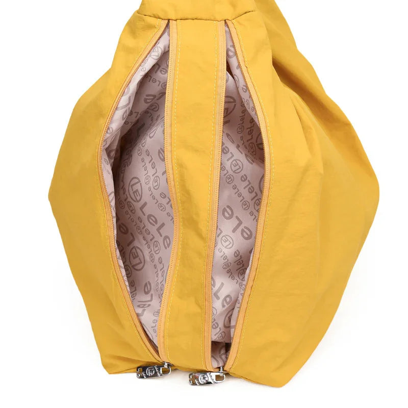 yellow dual-zippered bag with LeLe brand logo interior lining in beige