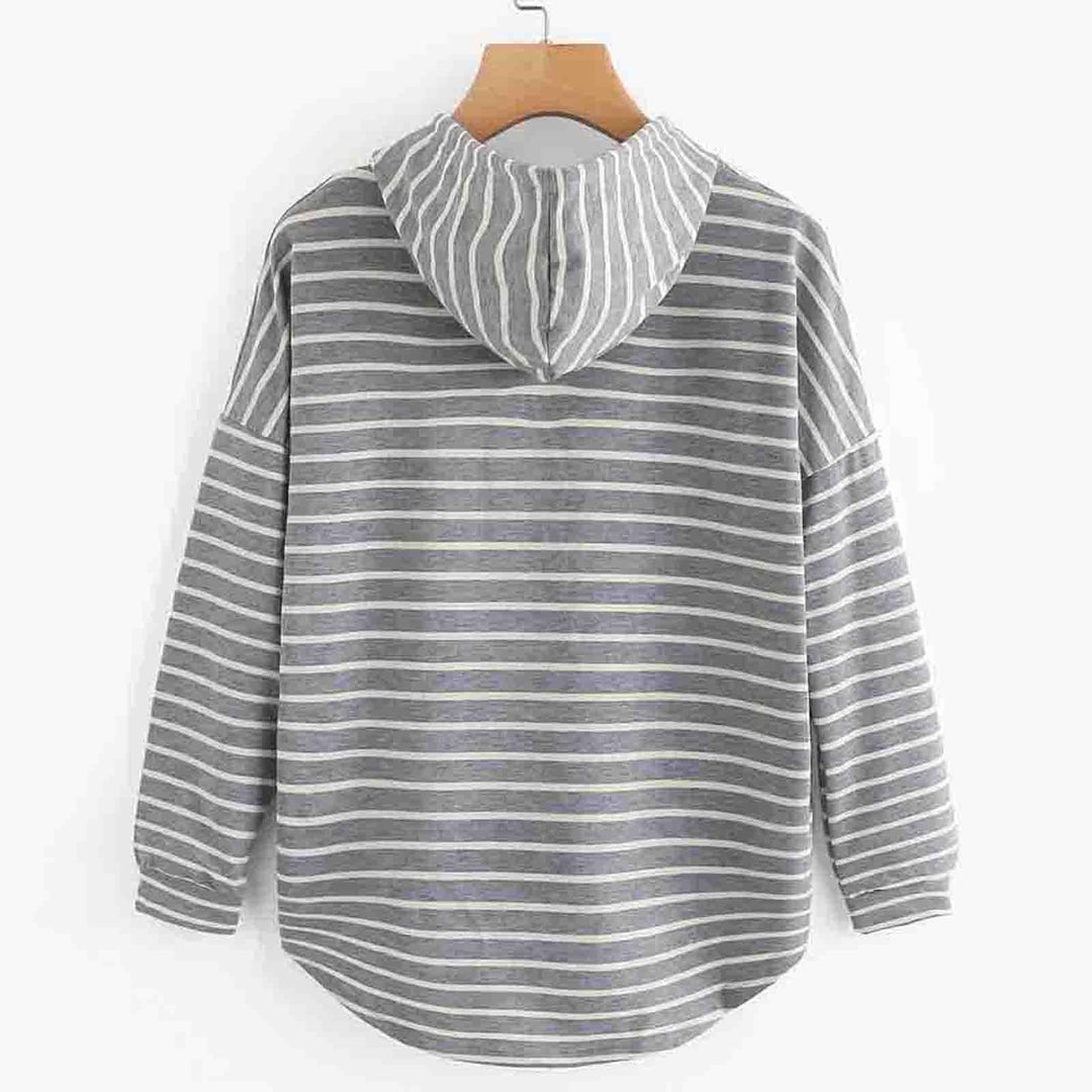 Back view of gray and white striped hoodie with long sleeves hanging on wooden hanger