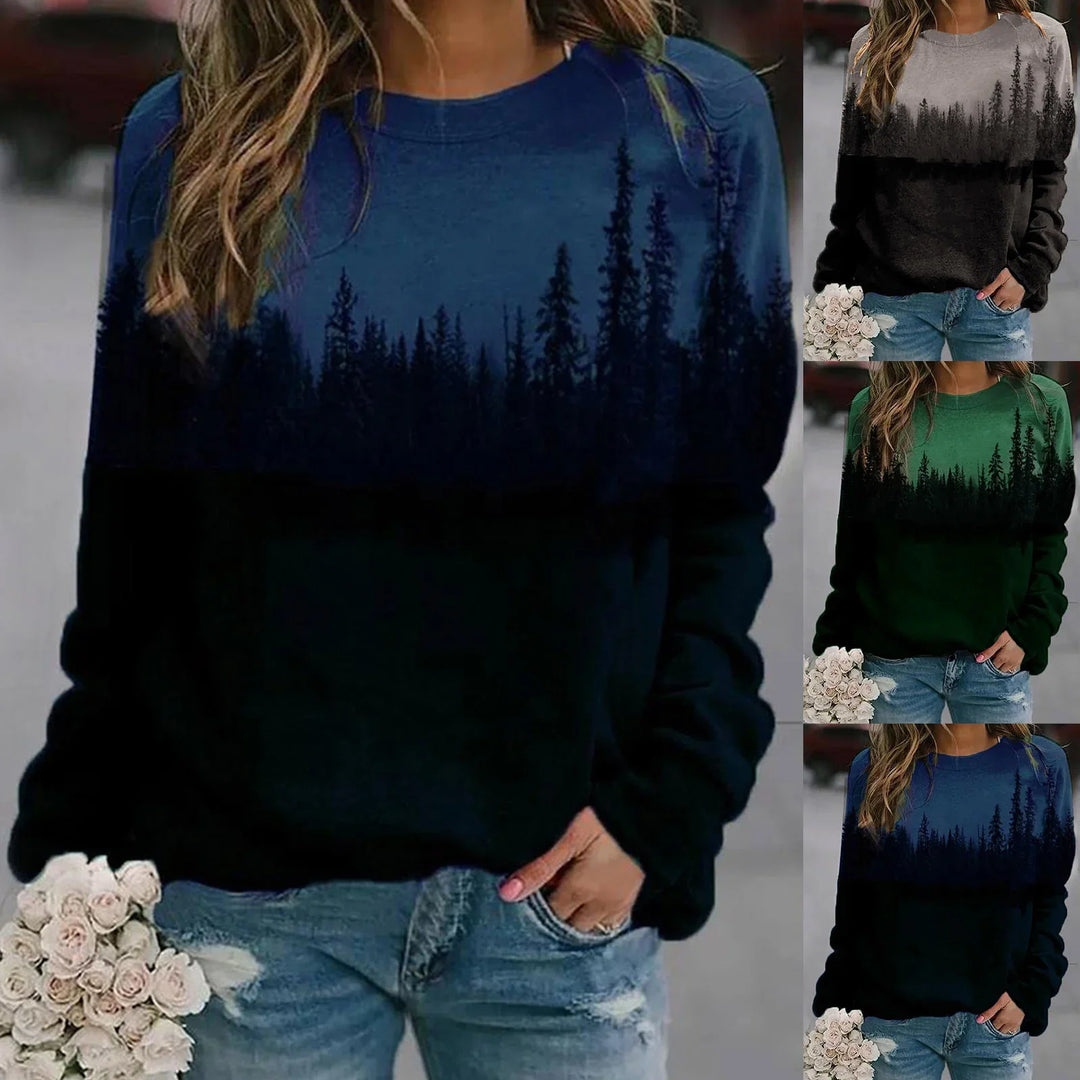 Woman wearing long-sleeve gradient sweatshirts with forest tree silhouette in blue, green, and grey colors