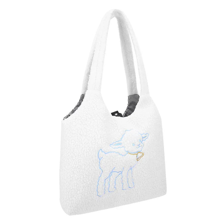 White textured handbag with soft handles and blue lamb embroidery on front