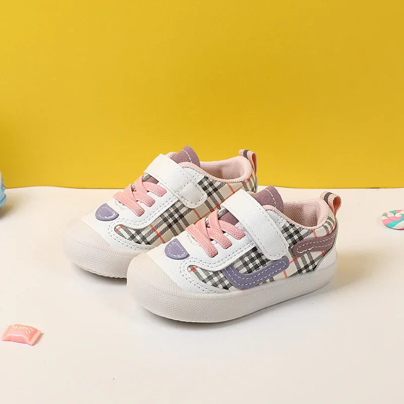 Toddler sneakers with pink laces, white hook-and-loop strap, and checkered pattern on yellow background