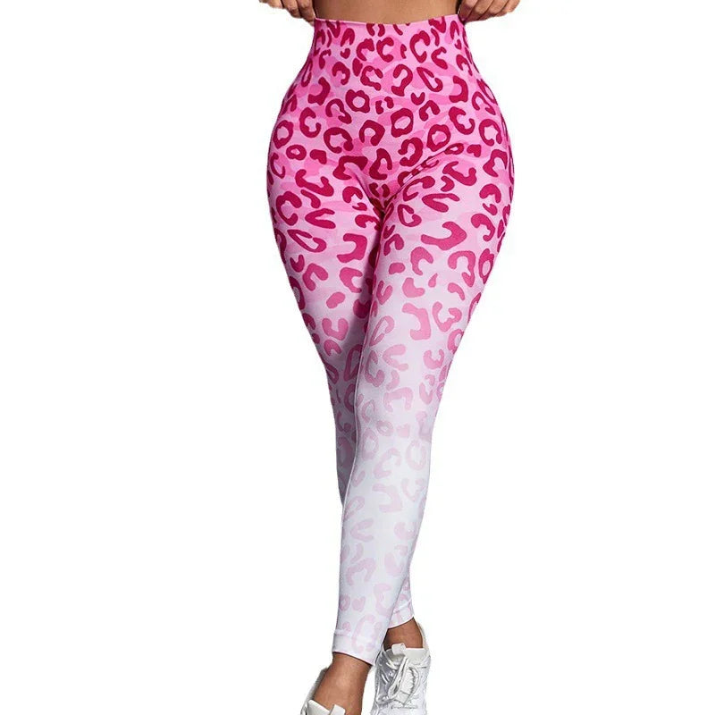 Woman wearing high-waist pink leopard print ombre leggings and white sneakers on white background