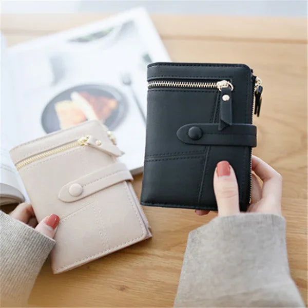 Two stylish women's wallets in black and beige with zipper compartments and button strap closure