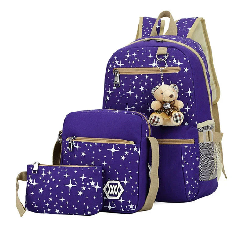 Purple star-patterned backpack set with beige straps, including backpack, shoulder bag, and pencil case with teddy bear keychain