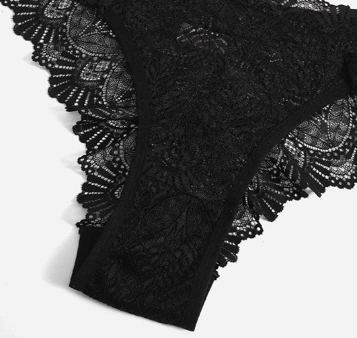 Black lace lingerie with intricate floral patterns and scalloped edges on white background