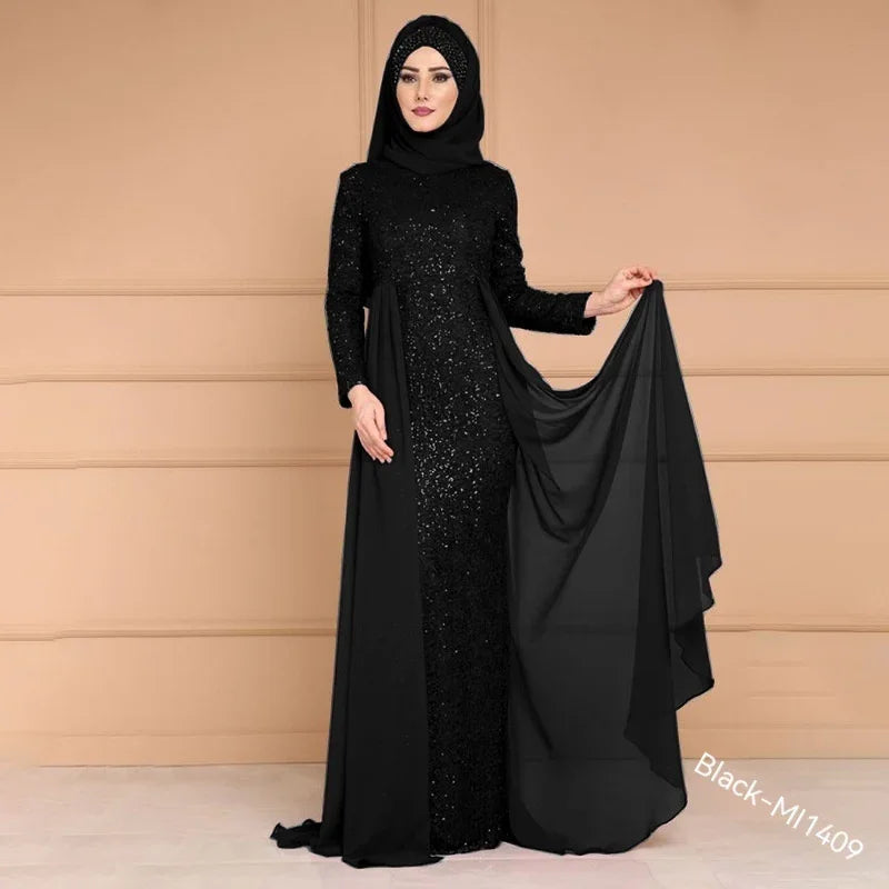 Woman wearing elegant black sequin abaya dress with matching hijab, holding flowing fabric in studio