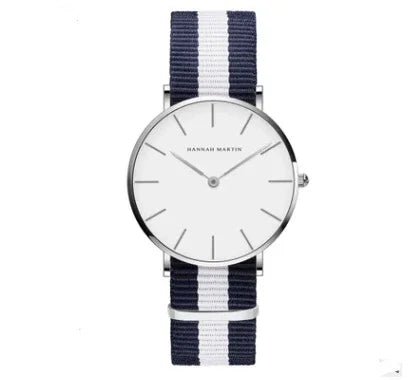 Minimalist Hannah Martin wristwatch with white dial and navy blue and white striped fabric strap