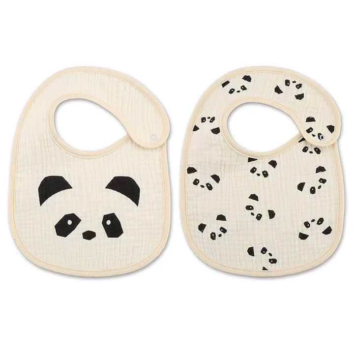 Two cream-colored baby bibs with black panda face and panda pattern designs, soft textured fabric