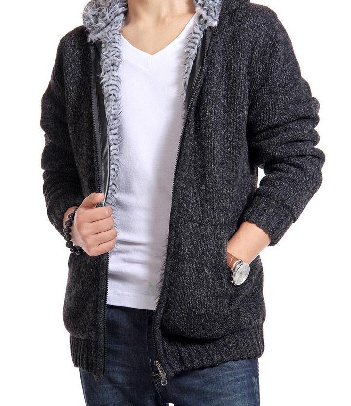 Man wearing dark gray knit zip-up hoodie with soft fleece lining, white t-shirt, and blue jeans