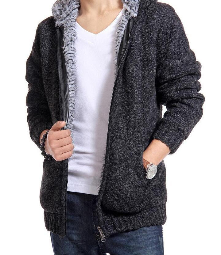 Man wearing dark gray knit zip-up hoodie with soft fleece lining, white t-shirt, and blue jeans