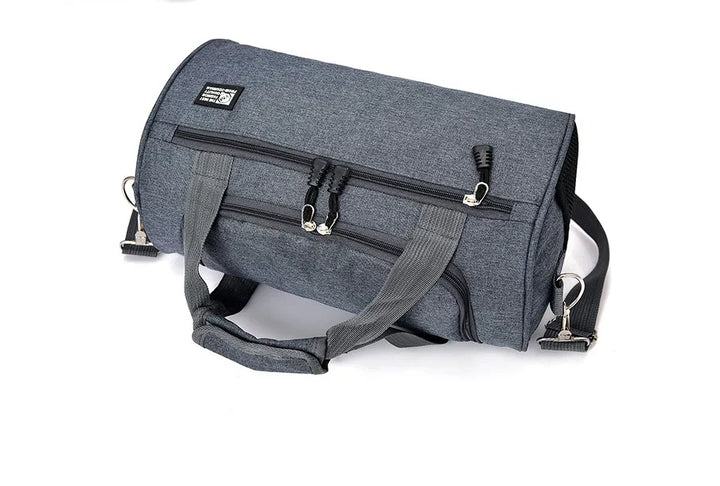 Gray fabric duffel bag with black zippers and handles on a white background