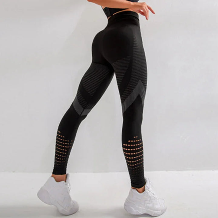 Woman wearing black seamless high-waisted leggings with geometric patterns and white sneakers