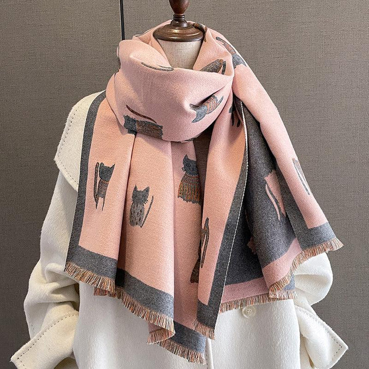 Soft pink and gray scarf with cat motifs wrapped on a white coat mannequin display