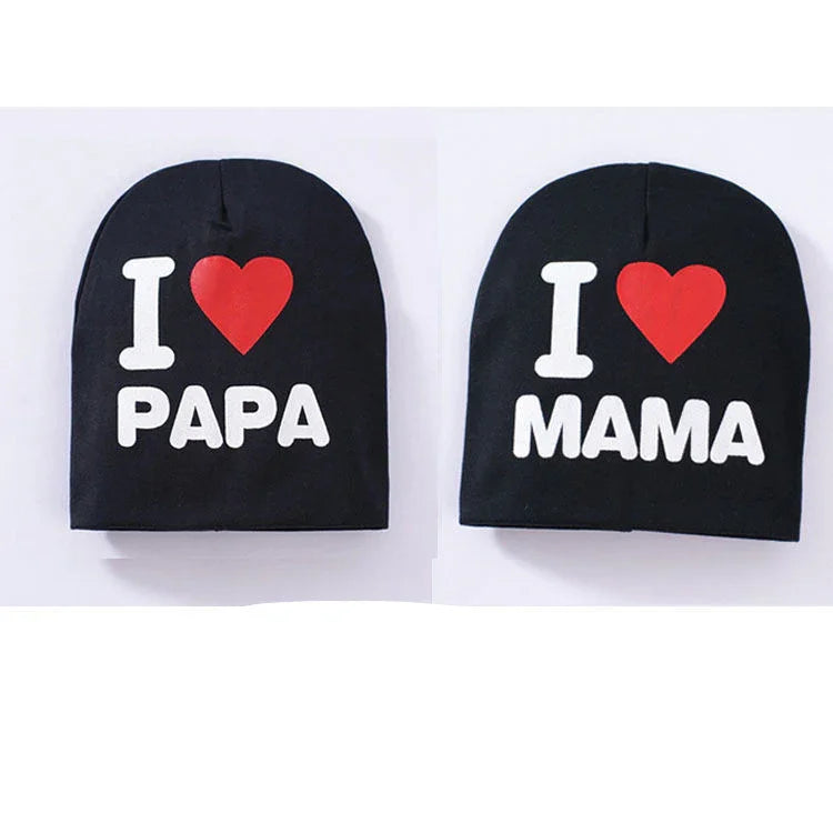 Black beanies with white text and red hearts reading I love Papa and I love Mama