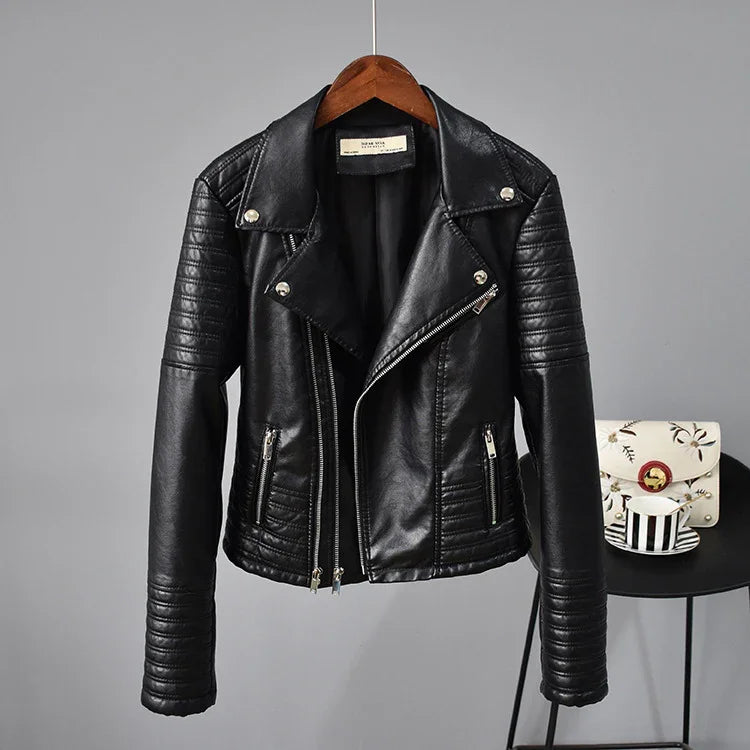 Black faux leather biker jacket with zippered pockets and quilted sleeves on wooden hanger