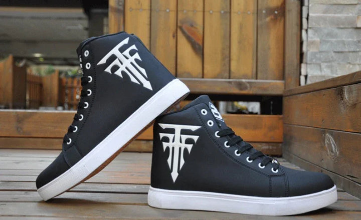 Black high-top sneakers with white sole and white logo on wooden surface