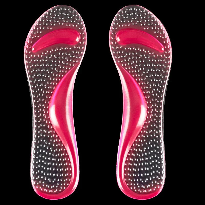 Pair of transparent pink gel insoles with raised massage nodules on black background