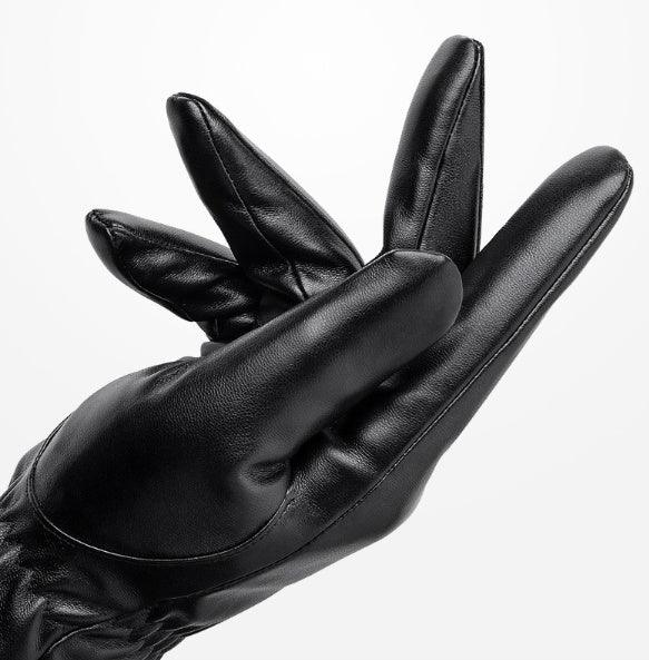 Close-up of black leather glove worn on hand with fingers slightly spread against white background