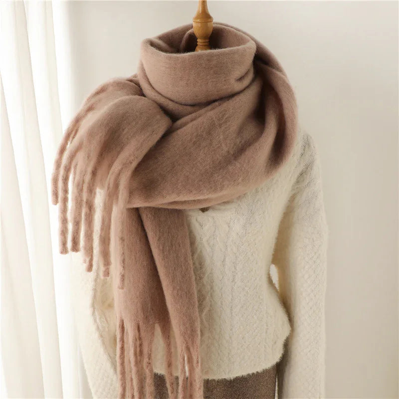 Cozy brown wool scarf with fringes wrapped on mannequin wearing white cable knit sweater