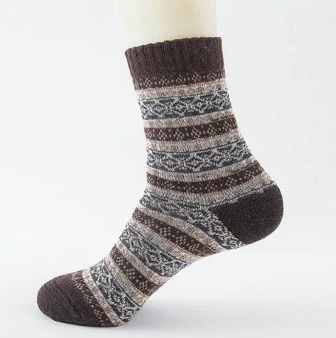 Brown and gray patterned wool sock on a mannequin foot with striped geometric design