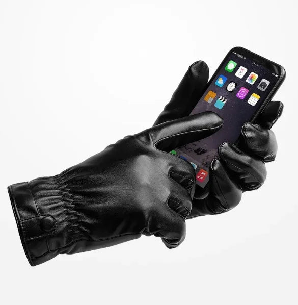 Black leather touchscreen gloves using smartphone with app icons visible on screen