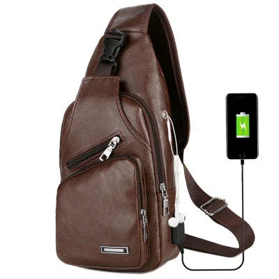 Brown leather sling backpack with USB charging port and earphones on white background