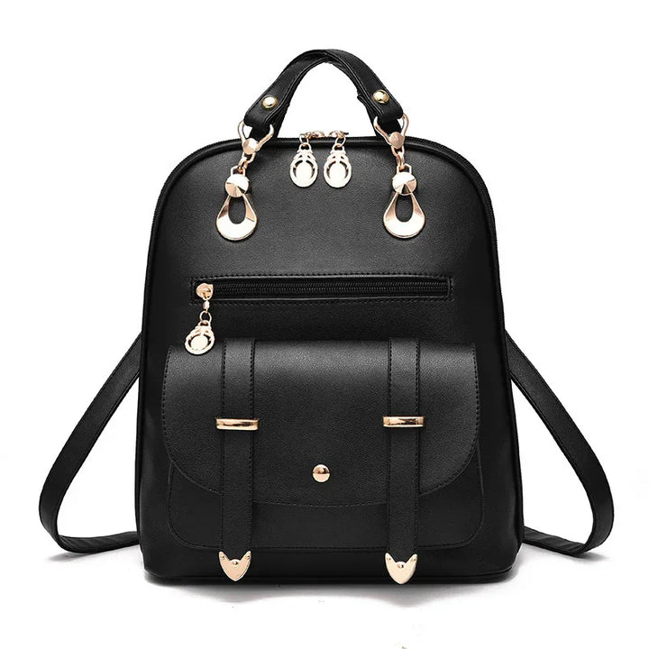 Black leather backpack with gold-tone hardware and front pocket against white background
