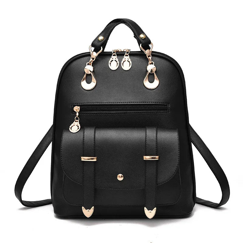 Black leather backpack with gold hardware, front pocket, zipper, and top handle straps
